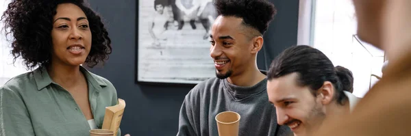 stock image Group of students talking while having a coffee break indoors