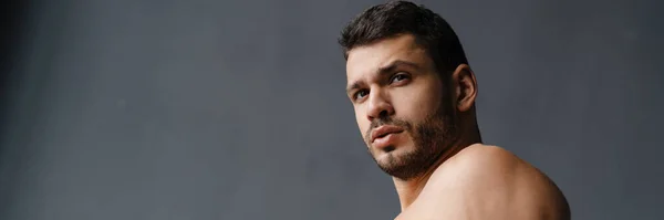 stock image Young shirtless sportsman doing exercise while working out indoors