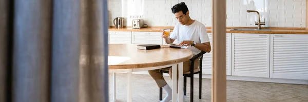 Young Hispanic Man Reading Book While Having Breakfast Kitchen Home — Stock Photo, Image