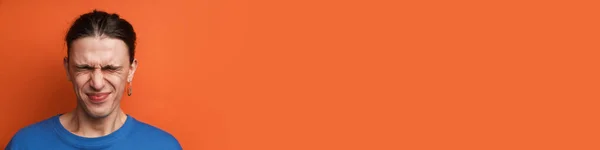 Young White Man Earring Posing Grimacing Camera Isolated Orange Background — Stock Photo, Image