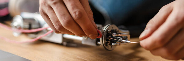 Young white man working with sewing machine indoors