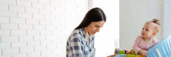 Young Mother Working Laptop While Keeping Her Baby Home — Stock Photo, Image