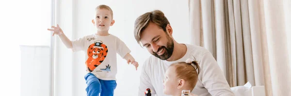 Fehér Apa Mosolyog Miközben Gyerekeivel Játszik Otthon Ágyon — Stock Fotó