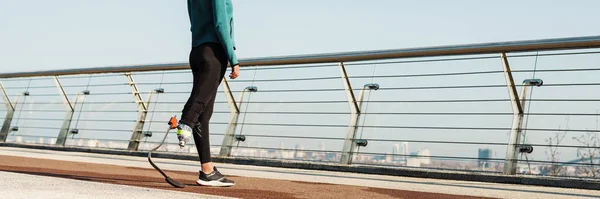 做假肢运动的年轻女运动员在城市桥上锻炼 — 图库照片