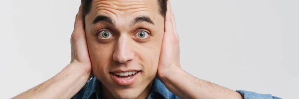 Young Excited Man Covering His Ears Looking Camera Isolated White — Stock Photo, Image