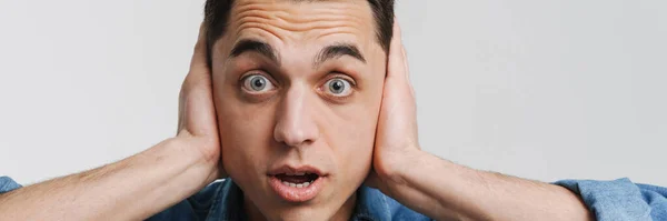 Young Shocked Man Covering His Ears Looking Camera Isolated White — Stock Photo, Image