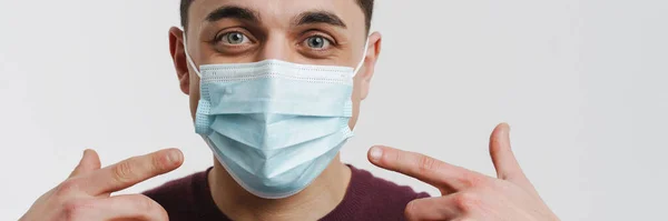 Young Brunette Man Pointing Fingers His Face Mask Isolated White — Stock Photo, Image