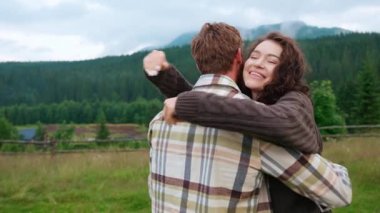 Birbirine aşık bir çift ormanda dağda sarılıyor.