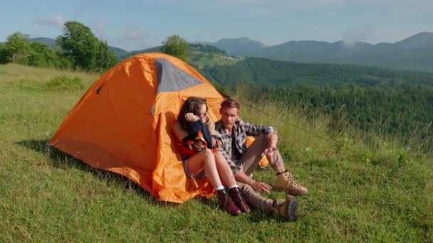 一对积极的夫妇坐在山上的帐篷里 一边看着风景 一边聊天 露营概念 — 图库视频影像