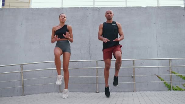 Confident Athletic African Couple Doing Jumping Jacks Spot Waterfront — Stock Video