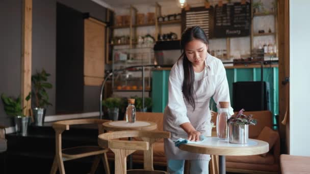 Smiling Asian Woman Waitress Apron Wiping Tables Cafe — Stock Video