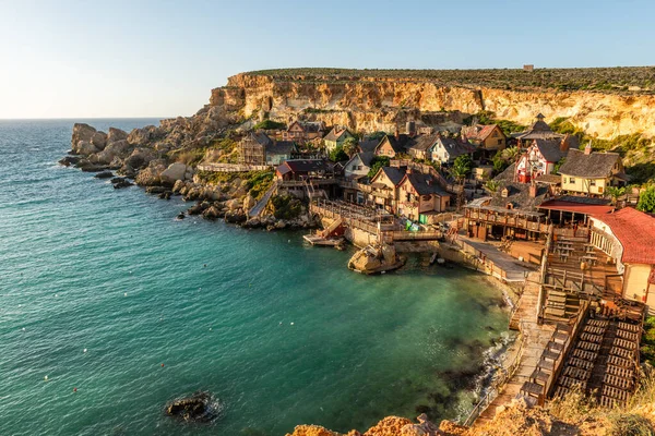 stock image Il-Mellieha, Malta - Panoramic skyline view of the famous Popeye Village at Anchor Bay at sunset.