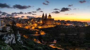 Il-Mellieha, Malta - Beautiful panoramic skyline view of Mellieha town after sunset with Paris Church.