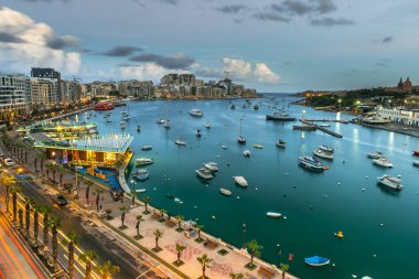 Evening at Sliema Bay promenade in Malta. Illuminated cityscape.