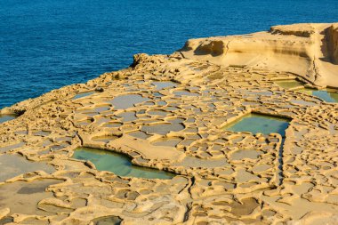 Salt pans in Xwejni Bay beach on the island of Gozo, Malta. Traditional crafts