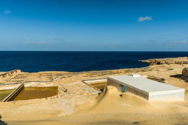 Salt pans in Xwejni Bay beach on the island of Gozo, Malta. Traditional crafts