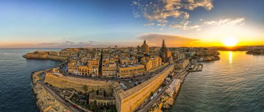 Valletta, Malta aerial panoramic view of old town at sunset.