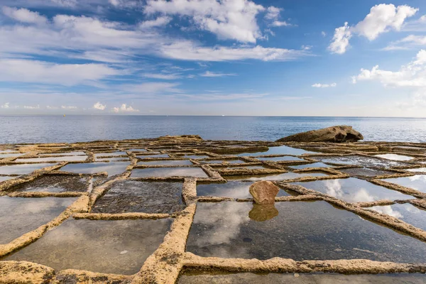 Salt pans on the beach in gozo, Malta.