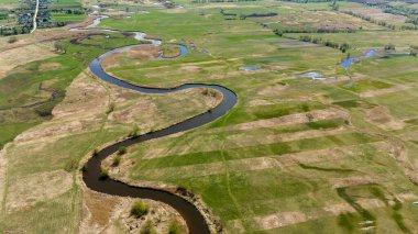 Bahar mevsiminde yukarıdan Nida Nehri 'nin etrafında dönüyordu.