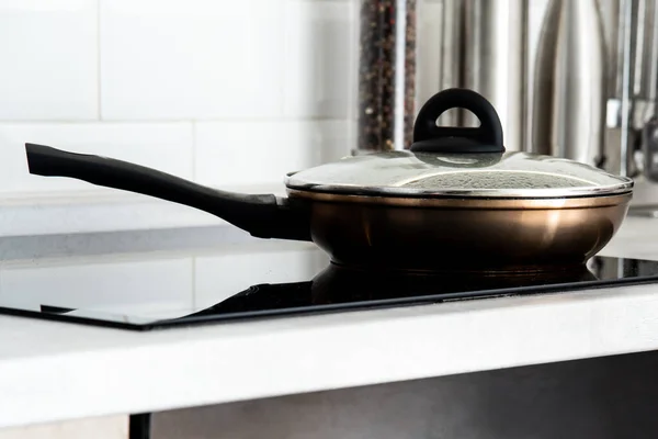 stock image Frying pan in modern kitchen with induction stove