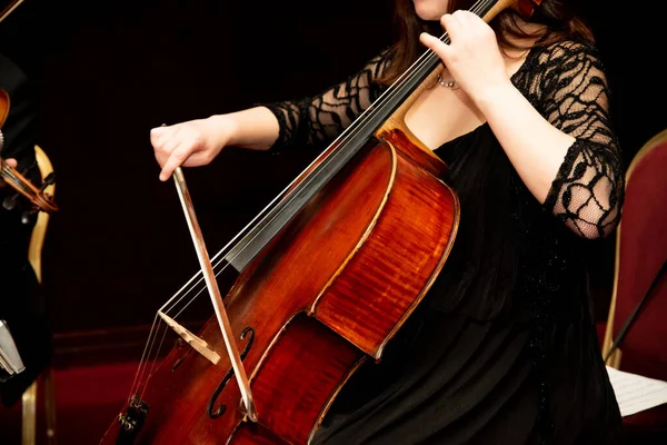 stock image Hands girl playing cello on a black background