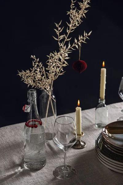 晚宴及庆祝活动概念 为黑色背景的丑闻圣诞餐桌而设的陶器及蜡烛 — 图库照片
