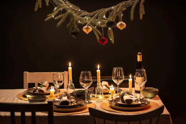 winter holidays, dinner party and celebration concept - scandinavian christmas table serving with burning candles at home at night