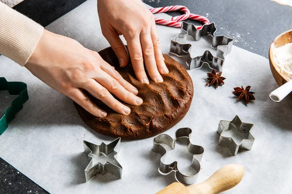 烹调和圣诞节概念 双手合拢 将姜饼面团铺在厨房黑桌上 — 图库照片