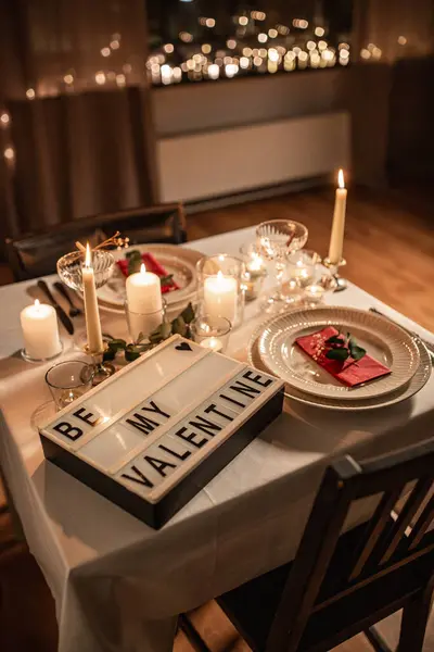 holidays, valentines day and celebration concept - close up of festive table serving with be my valentine words on light board at home at night