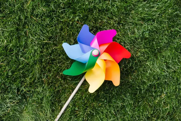 Ecology Environment Sustainable Energy Concept Close Multicolored Pinwheel Green Lawn Royalty Free Stock Photos