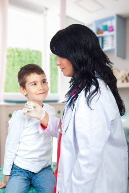 Küçük çocuk termometrenin sonuçlarını okurken tuhaf bir şekilde doktora baktı.