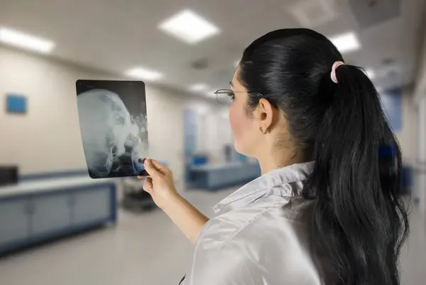 Woman Doctor examine a x-ray