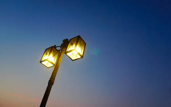 Light at lamp post with twilight sky background, Low angle view