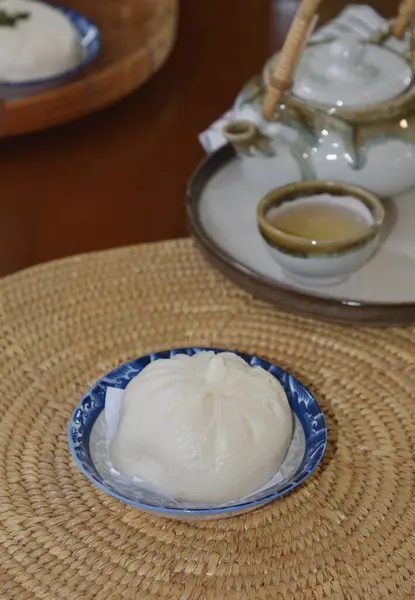 stock image Stuffed steamed bun at dish on table