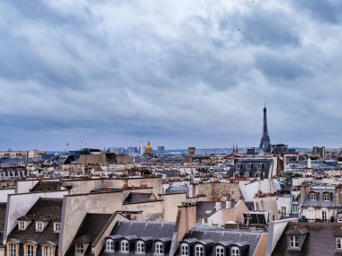 Eiffel tower over old buildings roofs and cityscape panorama Paris, France