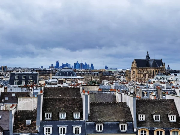 Panorama of Paris roofs with La Defense on background, France on moody day