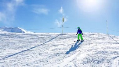 Child ride on ski slope downhill on beautiful mountain range with panorama French Alps Mont Blanc summits
