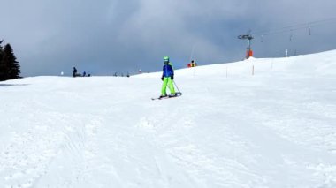 Child ride on ski slope downhill on beautiful mountain range with panorama French Alps Mont Blanc summits
