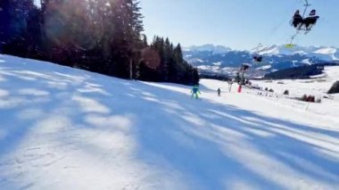 Boy ride fast on ski slope downhill on beautiful mountain range with panorama French Alps Mont Blanc summits