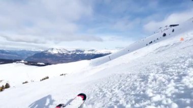 Fast motion shot of low angle from ski of skier go down on the alpine slope track