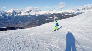 Boy ride  on ski slope downhill on beautiful mountain range with panorama French Alps Mont Blanc summits