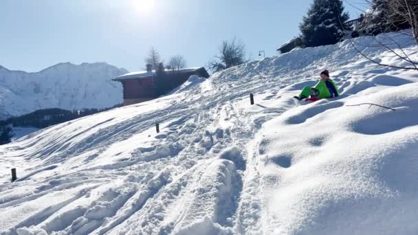 Boy Rides Sled Downhill Having Fun Mountains Winter Vacation — Stock videók