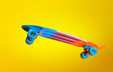 Profile image of flying color skate board isolated over yellow