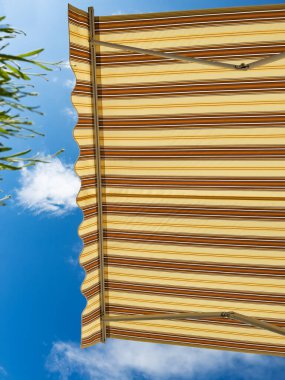 Summer window visor parasol retractable shade in cafe or home, view from below with some fresh lavender grass clipart