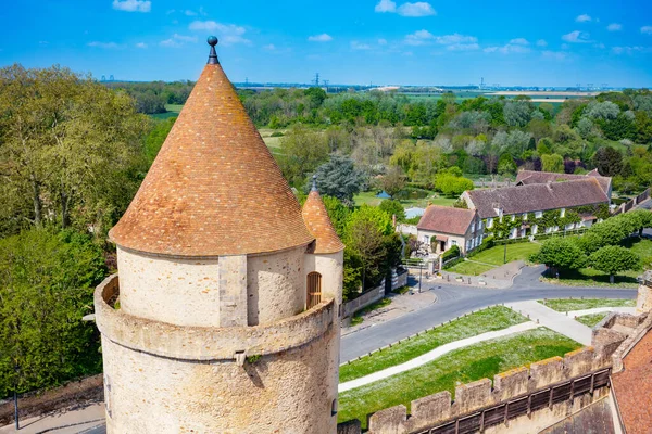Medieval castle tower and walls Blandy-les-Tours, France view from above towards village