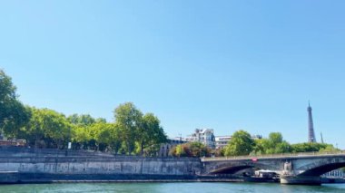 Eiffel tower in France view from the Seine river boat during hot summer day