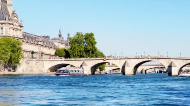 Bridge pont de la Concorde and Grand Palais building on back with boat on Seine river on summer sunny day