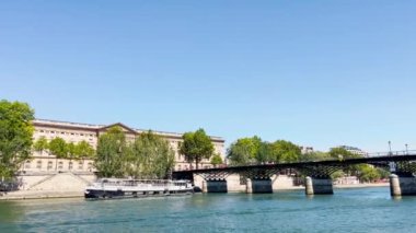 Bridge pont de la Concorde and Grand Palais building on back with boat on Seine river on summer sunny day