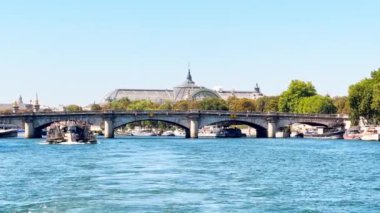 Bridge pont de la Concorde and Grand Palais building on back with boat on Seine river on summer sunny day