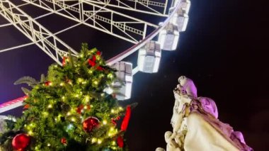Huge beautiful Ferris wheel illuminated attraction rotating over night sky